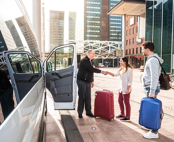 People with luggage heading to the airport